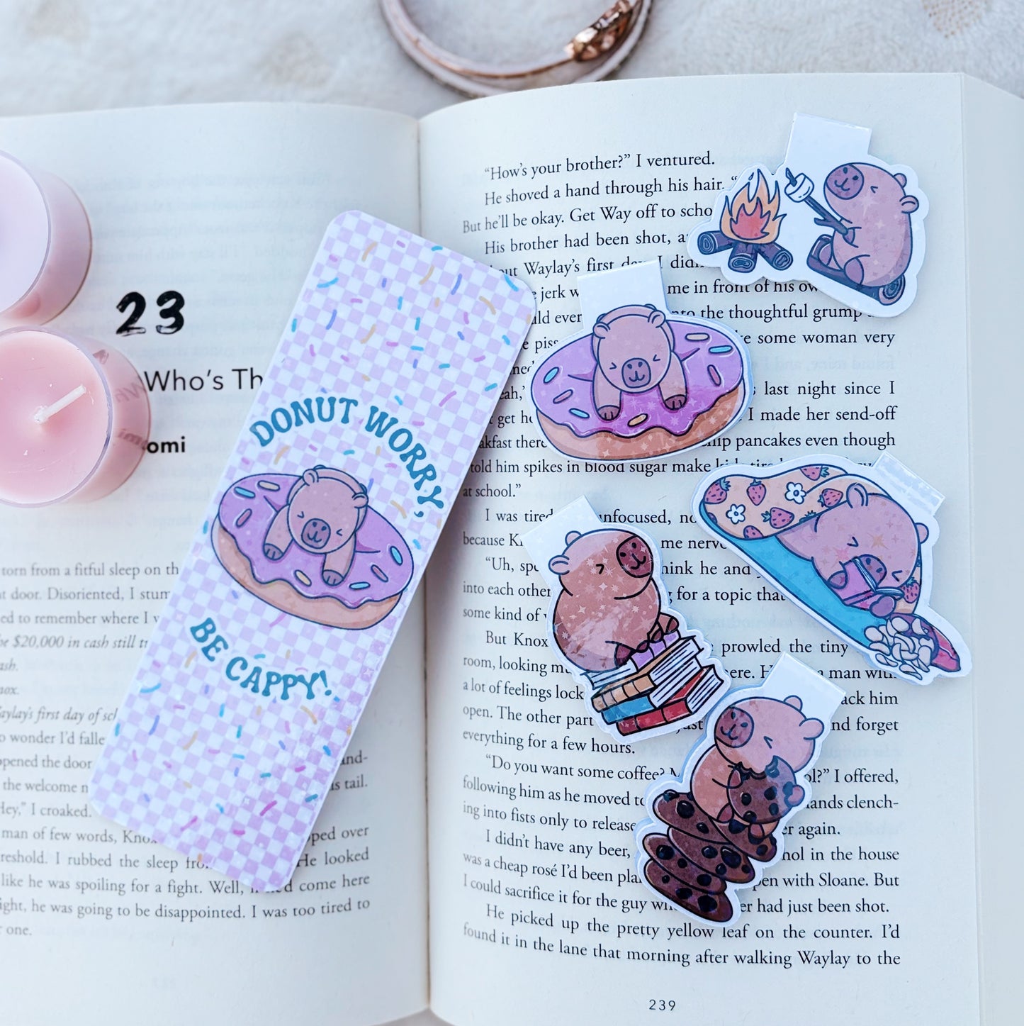 Capybara laying down and reading magnetic bookmark