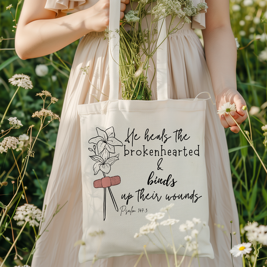 He heals the brokenhearted tote bag